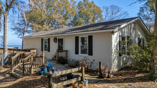 back of property featuring a wooden deck