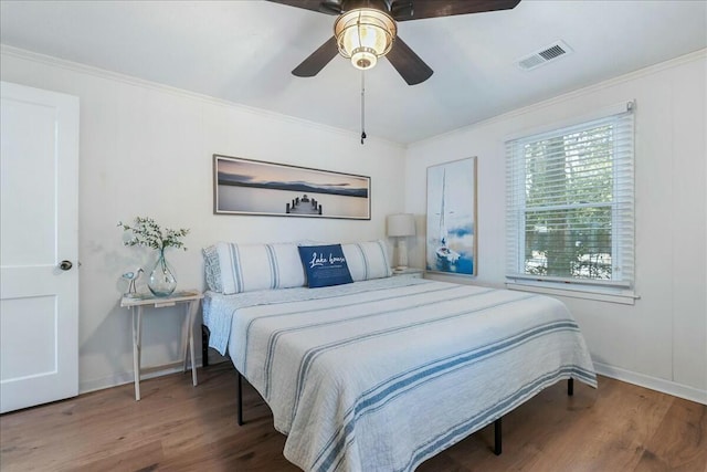 bedroom featuring crown molding, ceiling fan, and wood-type flooring