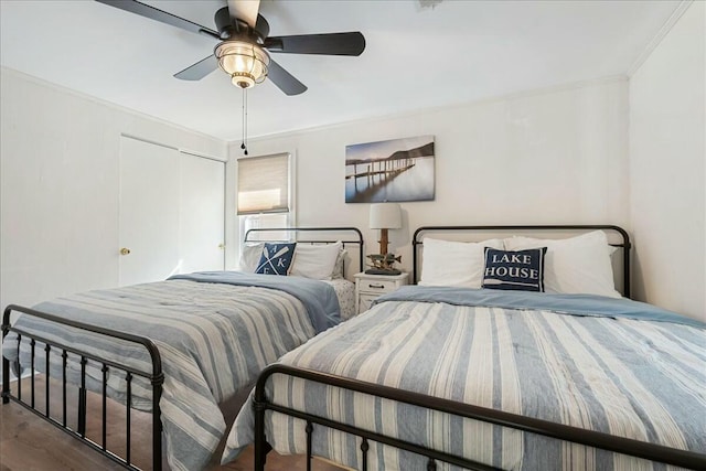 bedroom with ornamental molding, wood-type flooring, and ceiling fan