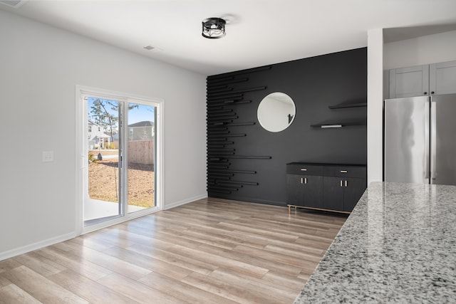 unfurnished dining area with light hardwood / wood-style flooring