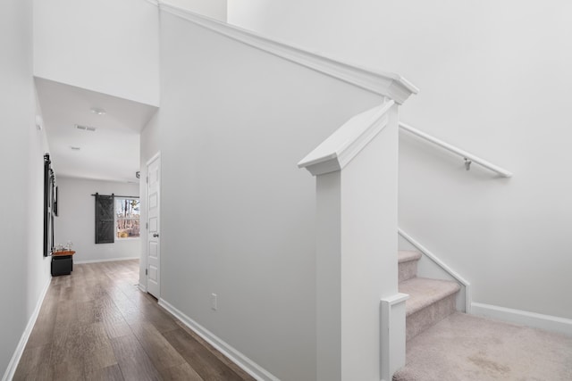 stairway with hardwood / wood-style floors