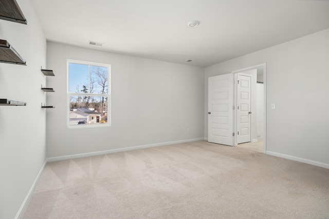 unfurnished room with light colored carpet