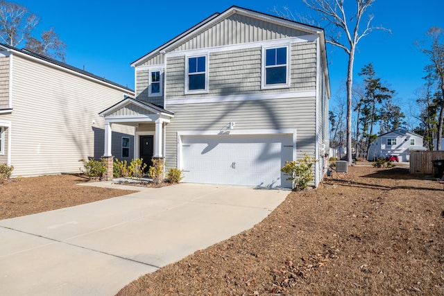 view of front of home featuring central air condition unit and a garage