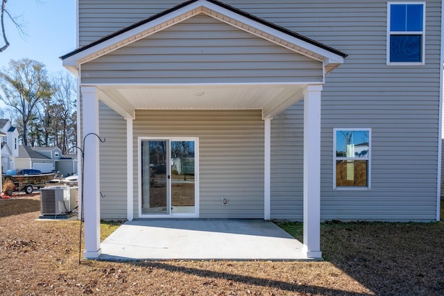 rear view of house with a patio area and central AC unit