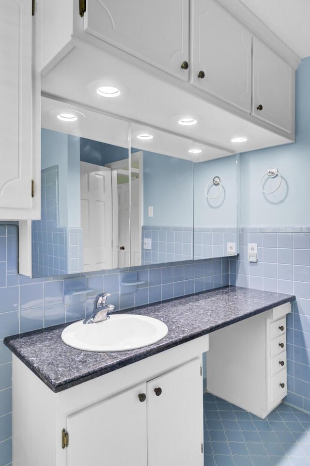 bathroom with tile walls and vanity