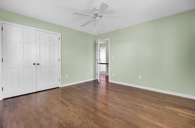 unfurnished bedroom with a closet, baseboards, ceiling fan, and wood finished floors
