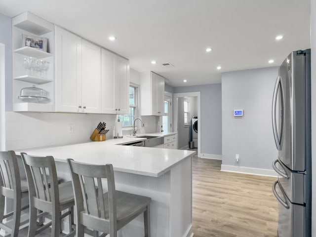 1410 Diamond Blvd, Mount Pleasant, SC 29466 - kitchen featuring freestanding refrigerator, white cabinets, backsplash, recessed lighting, and light wood-style flooring