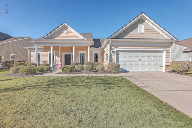 view of front of house featuring a garage, a front yard, and a porch