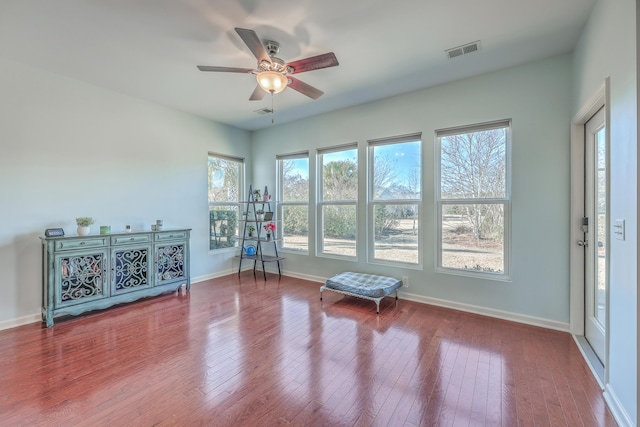 workout area featuring hardwood / wood-style flooring and ceiling fan