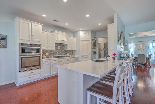 kitchen with white cabinetry, sink, tasteful backsplash, and appliances with stainless steel finishes