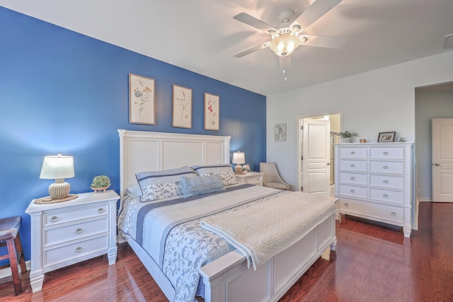 bedroom with dark hardwood / wood-style flooring and ceiling fan