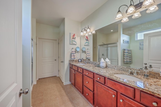 bathroom featuring tile patterned floors, vanity, and an enclosed shower