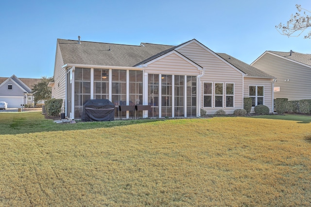 back of house with a lawn and a sunroom