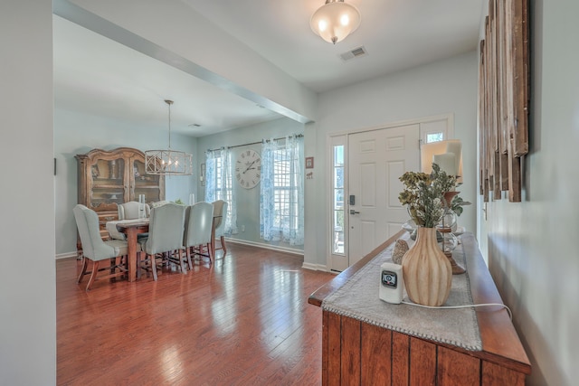 foyer entrance featuring an inviting chandelier and hardwood / wood-style floors