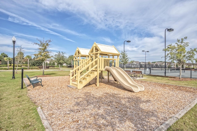 view of play area featuring tennis court