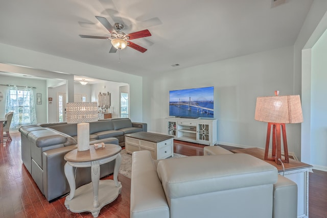 living room with ceiling fan and dark hardwood / wood-style floors