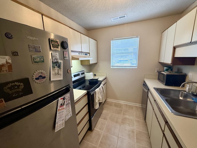kitchen featuring white cabinets, appliances with stainless steel finishes, a sink, under cabinet range hood, and visible vents