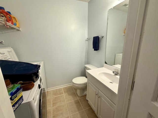 half bath featuring vanity, baseboards, tile patterned floors, and toilet