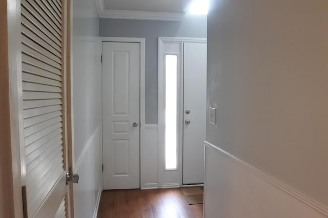 entryway featuring ornamental molding and wood finished floors