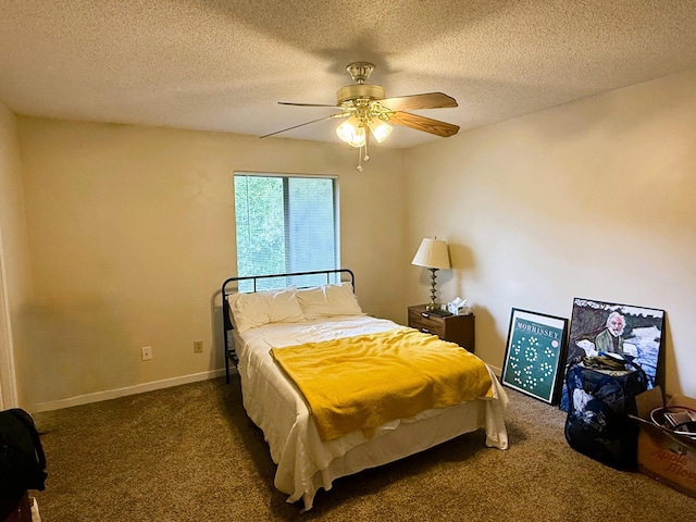 bedroom with a ceiling fan, carpet flooring, and a textured ceiling
