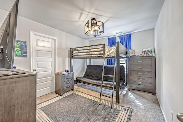 carpeted bedroom with visible vents and baseboards