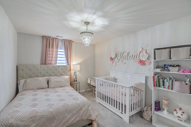 carpeted bedroom featuring visible vents, baseboards, and an inviting chandelier