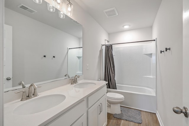 full bathroom with toilet, visible vents, and a sink