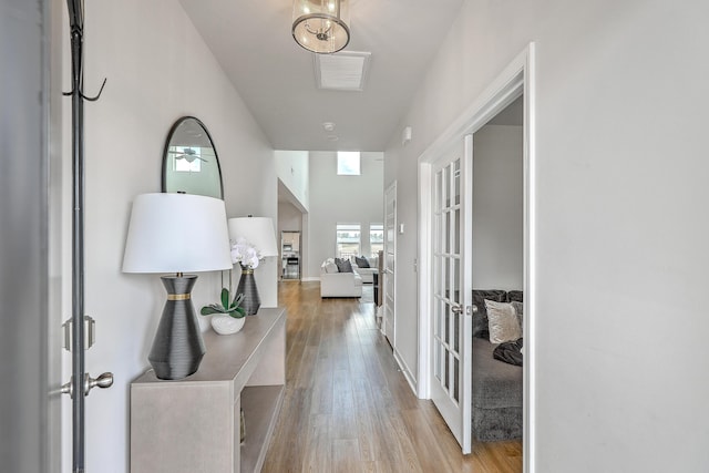 hall featuring french doors, wood finished floors, and visible vents