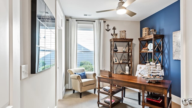 carpeted office featuring ceiling fan