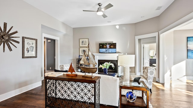 living room featuring ceiling fan and wood-type flooring