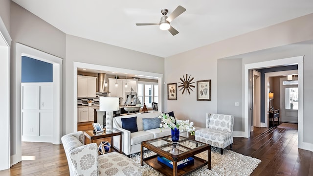 living room featuring dark hardwood / wood-style flooring and ceiling fan