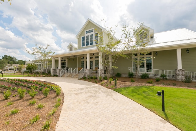 farmhouse inspired home with covered porch and a front lawn