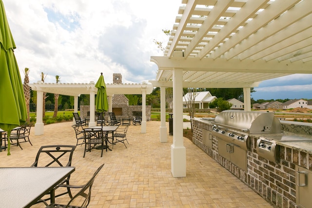 view of patio with an outdoor kitchen, area for grilling, and a pergola