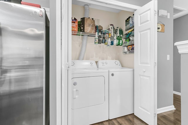 washroom with separate washer and dryer and dark hardwood / wood-style floors