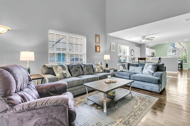 living room with ceiling fan and light hardwood / wood-style floors