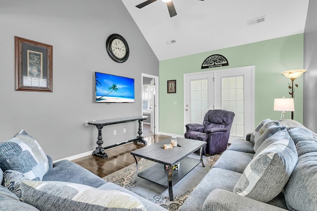 living room with wood-type flooring, high vaulted ceiling, ceiling fan, and french doors