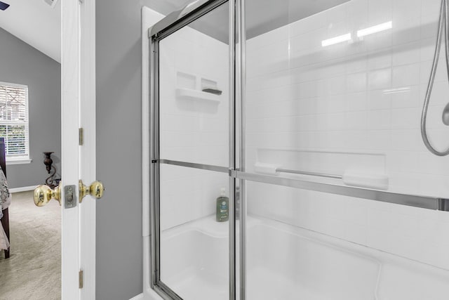 bathroom with lofted ceiling and an enclosed shower