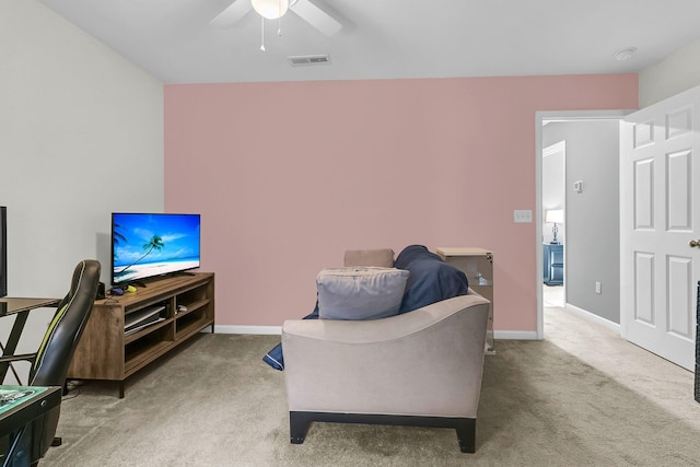 living room with ceiling fan and carpet