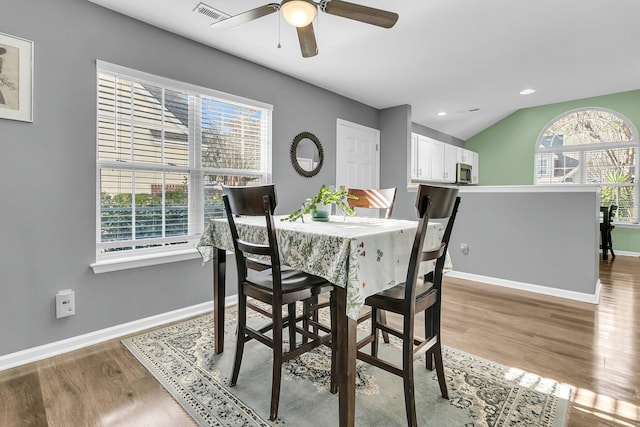 dining room with lofted ceiling, ceiling fan, and light hardwood / wood-style floors