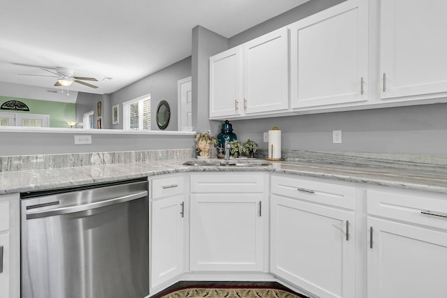 kitchen with sink, white cabinetry, ceiling fan, stainless steel dishwasher, and light stone countertops