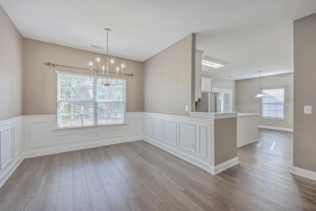 401 Waring St, Summerville, SC 29483 - unfurnished dining area with a wealth of natural light, visible vents, a notable chandelier, and wood finished floors
