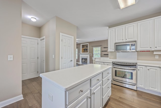 401 Waring St, Summerville, SC 29483 - kitchen with light wood-type flooring, appliances with stainless steel finishes, a center island, and white cabinetry