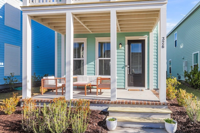 view of exterior entry featuring a porch