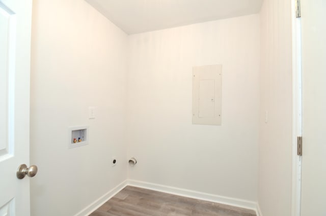 laundry room featuring washer hookup, light wood finished floors, laundry area, electric panel, and baseboards