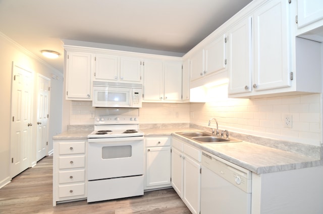 kitchen featuring crown molding, white appliances, sink, and light hardwood / wood-style floors