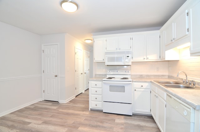 kitchen with white cabinetry, white appliances, sink, and light hardwood / wood-style floors