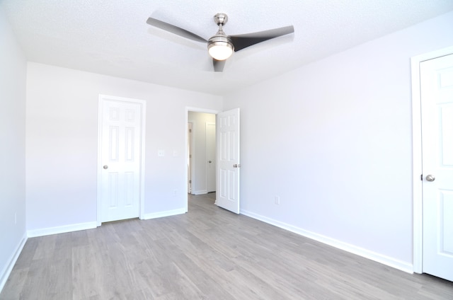 unfurnished bedroom with ceiling fan, a textured ceiling, and light hardwood / wood-style flooring