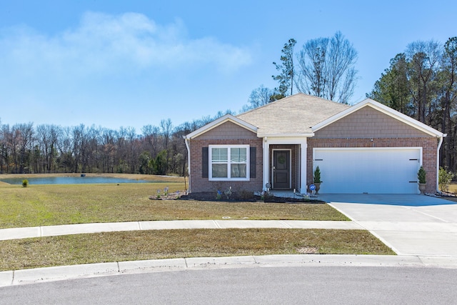 view of front of home featuring a garage, brick siding, a water view, concrete driveway, and a front yard