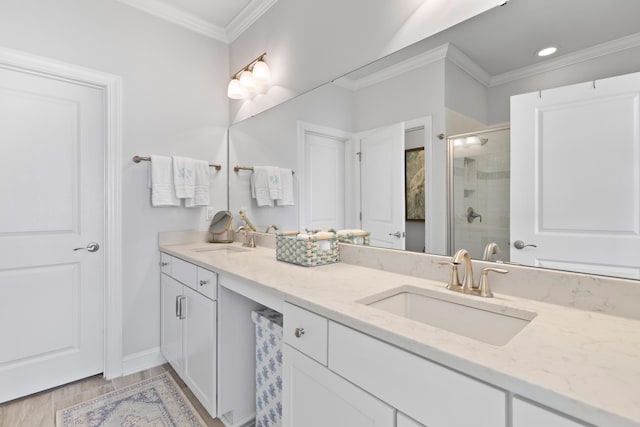 bathroom with hardwood / wood-style floors, an enclosed shower, vanity, and ornamental molding