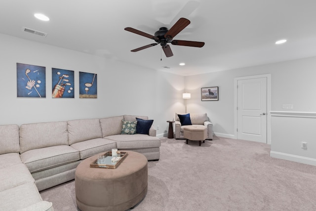 carpeted living room with ceiling fan